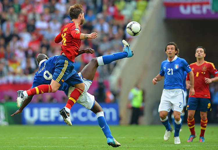 Spanish defender Sergio Ramos vies with Italian forward Mario Balotelli during the Euro 2012 championships Spain vs Italy football match. (Gabriel Bouys/AFP/GettyImages)