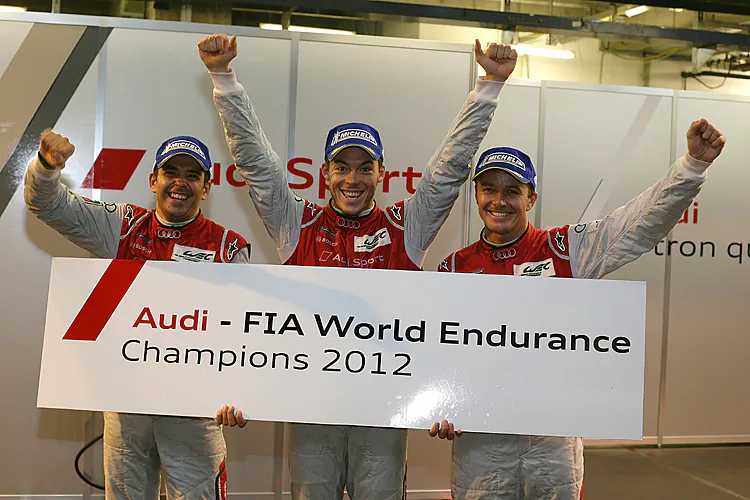 Benoît Tréluyer, André Lotterer, and Marcel Fässler celebrate winning the 2012 WEC drivers’ championship. (Audi Motorsport)
