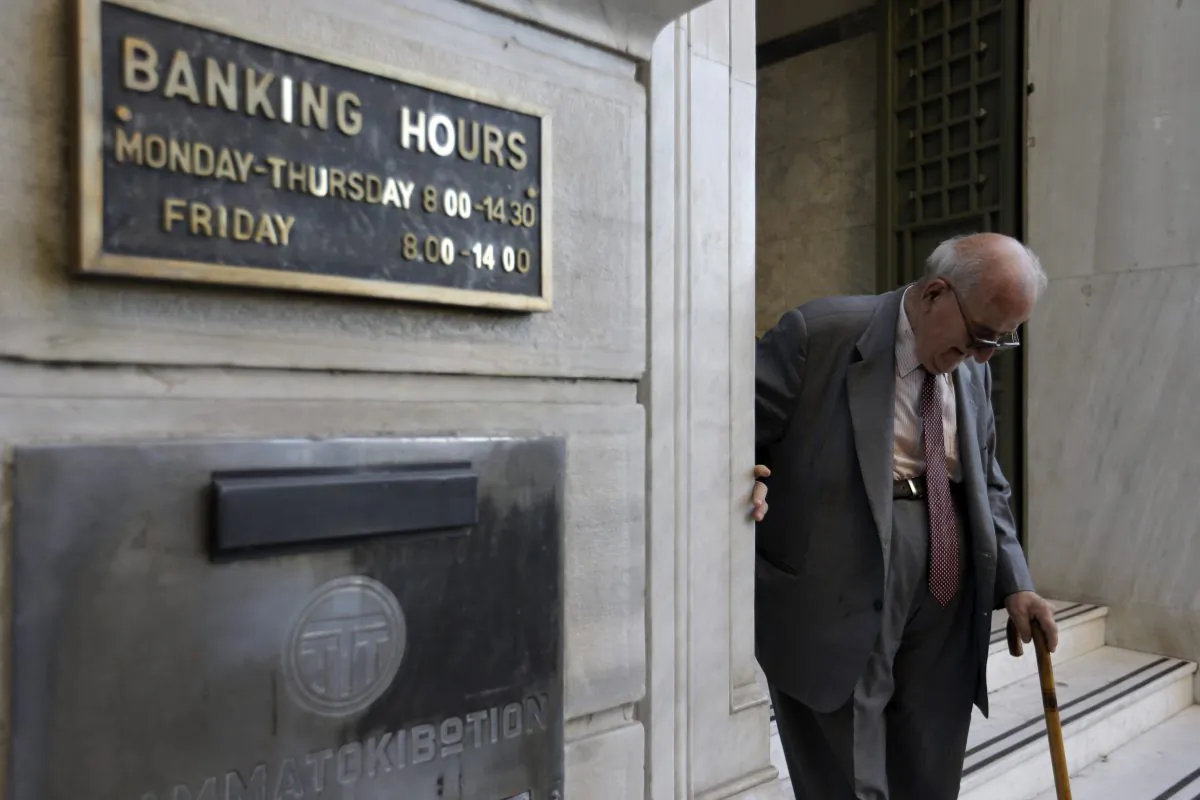 An elderly man leaves a branch of the National Bank of Greece in Athens, Monday, July 20, 2015. (AP Photo/Thanassis Stavrakis)