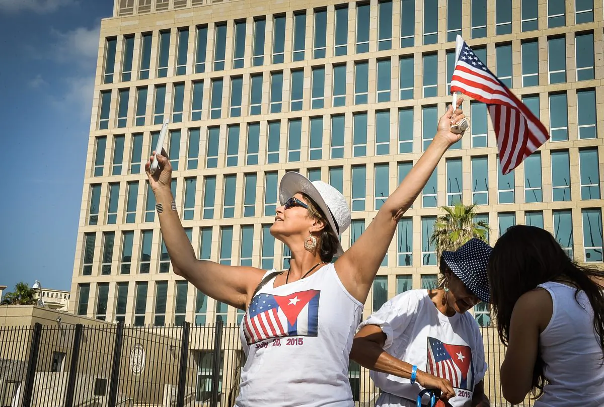 A tourist makes a selfie holding a US Flag in front of the US Embassy in Havana on July 20, 2015.  (Adalberto  Roque/AFP/Getty Images)