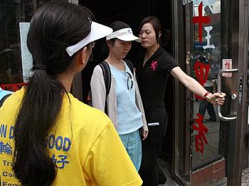 Ms. Zhenyu Sun and her friends are forced to leave the Lucky Joy Restaurant solely because they support Falun Gong.(Evan Mantyk/The Epoch Times)