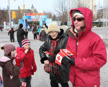 A family attends the flag-raising ceremony outside Ottawa City Hall to celebrate National Flag of Canada Day, Feb. 15, 2010. (Gerry Smith/The Epoch Times)