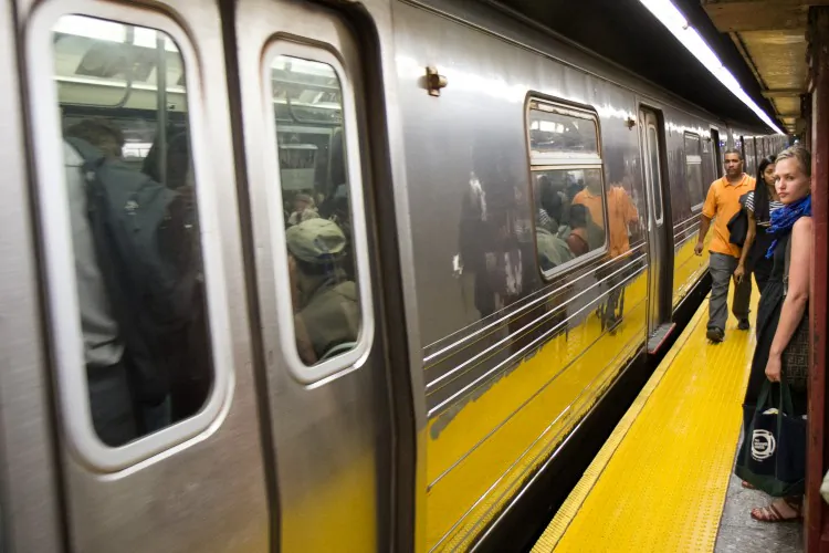 Commuters using their MTA Metro cards at the turnstile of the Harold Square subway station on May 23. (Benjamin Chasteen/The Epoch Times)