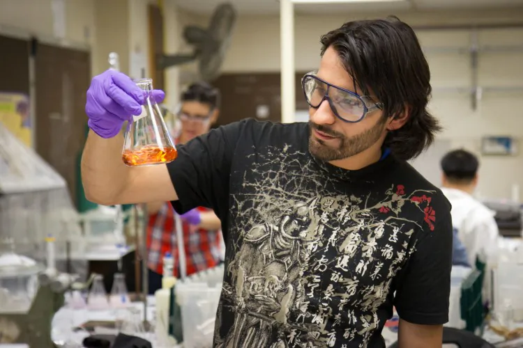 Mubashar Ahmed and a classmate test solutes in water at a lab in the John Jay College of Criminal Justice in Manhattan on June 18. (Benjamin Chasteen/The Epoch Times)