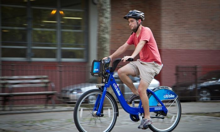 New Yorker Tim Haney tests out one of the bikes from Citi Bike at a recent demonstration of the system. The tentative rollout has been delayed to August. (Benjamin Chasteen/The Epoch Times)