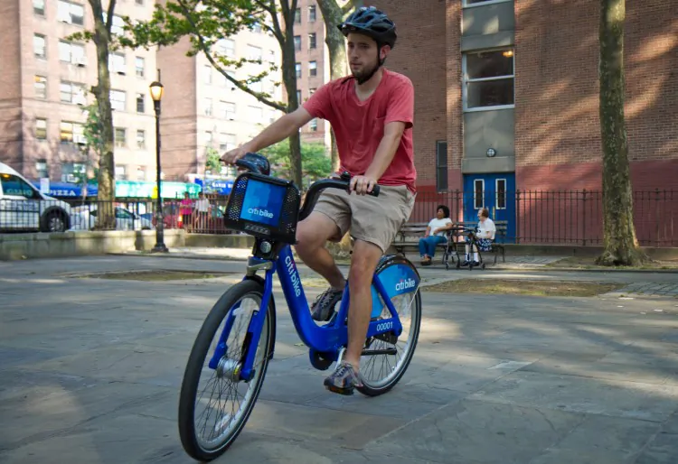 Tim Haney tests out a bike in June during a demonstration of the upcoming bike-share program, Chinatown, Manhattan. Rollout of the system in New York has been delayed again until May 2013. (Benjamin Chasteen/The Epoch Times)