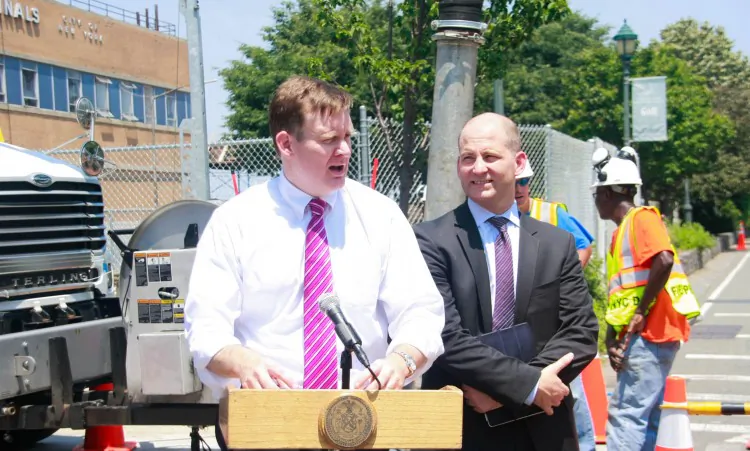 Carter Strickland Jr., (L), the city’s Department of Environmental Protection commissioner, and Cas Holloway, deputy mayor, announced Thursday the completed cleaning of 26 miles of pipe. (Aric Chen/The Epoch Times)