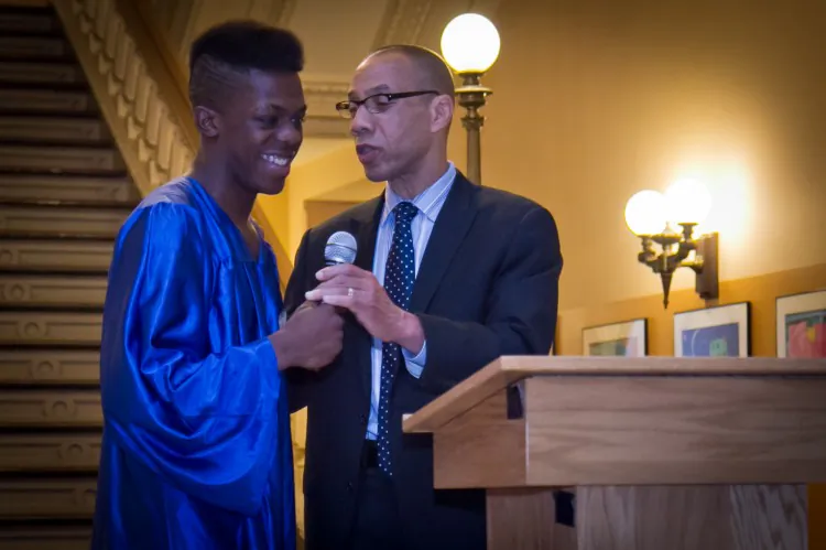 The New York City Schools Chancellor, Dennis M. Walcott, stands with Remarkable Achievement Award recipient, Cyrus Dennis. Dennis grew up in foster care after he was taken away from his violent, schizophrenic mother. (Benjamin Chasteen/The Epoch Times)