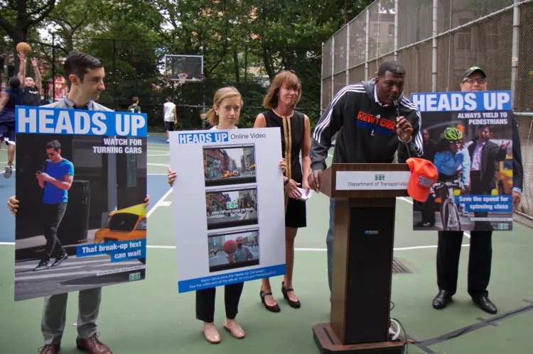 Former NBA star Larry Johnson speaks at a press conference with Commissioner Sadik-Khan of the Department of Transportation at the basketball courts in Washington Square about Heads Up, a street safety ad campaign for the city in Manhattan on June 26. (Benjamin Chasteen/The Epoch Times)