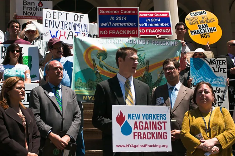 Thomas Cluderay, assistant general counsel for Environmental Working Group, discusses questionable meetings between oil and gas companies and the DEC at a rally on the steps of City Hall in Manhattan on Tuesday. (Kristen Meriwether/The Epoch Times)
