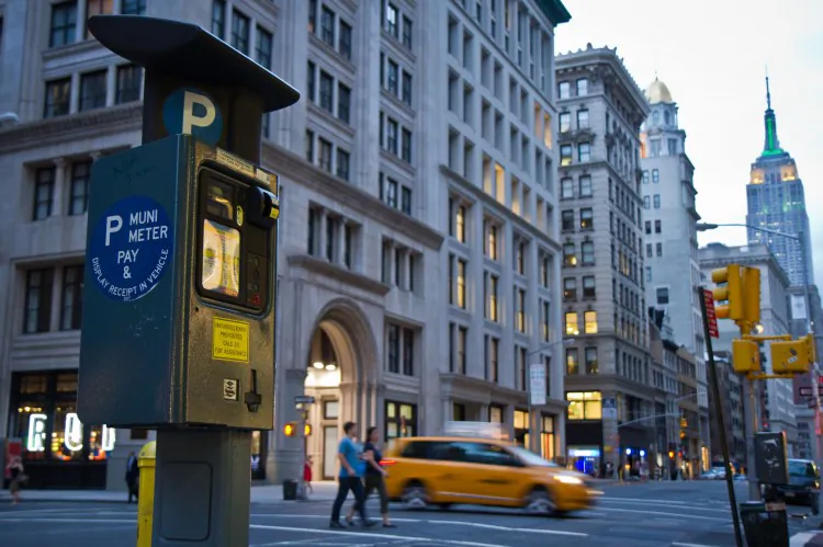 Pedestrians walk by a Muni parking meter in the Flatiron District of Manhattan on July 30, 2012. (Benjamin Chasteen/The Epoch Times)