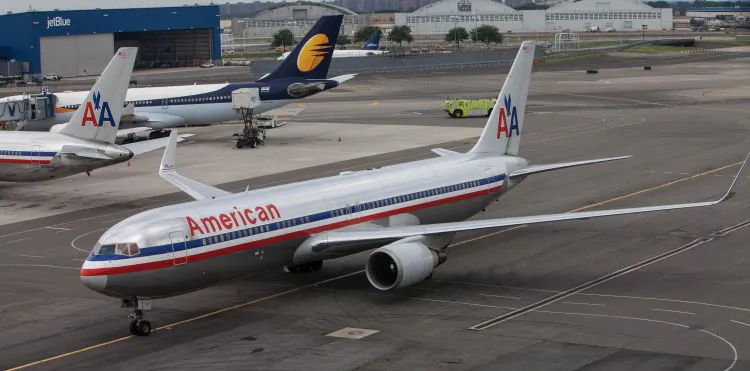 An American Airlines plane coasts down the runway at the JFK airport after landing on Aug. 14, 2012 in New York City. (Benjamin Chasteen/The Epoch Times)