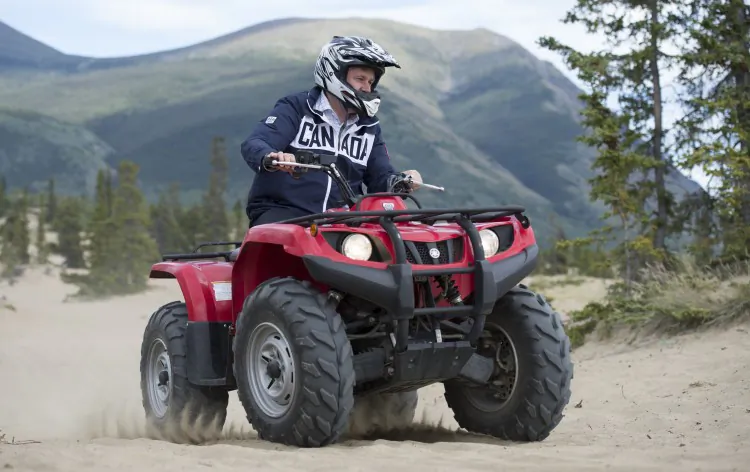 Prime Minister Stephen Harper rides an ATV in Yukon’s Carcross Desert, the smallest desert in the world. Harper arrived in Yukon Aug. 20 for his seventh annual tour of the Canadian North. He is accompanied by Health Minister Leona Aglukkaq and Aboriginal Affairs and Northern Development Minister John Duncan. The trip also includes a visit to the Northwest Territories, Nunavut, and northern Manitoba. The PM is expected to make several announcements in support of the economic and social development of the North. (Jason Ransom)