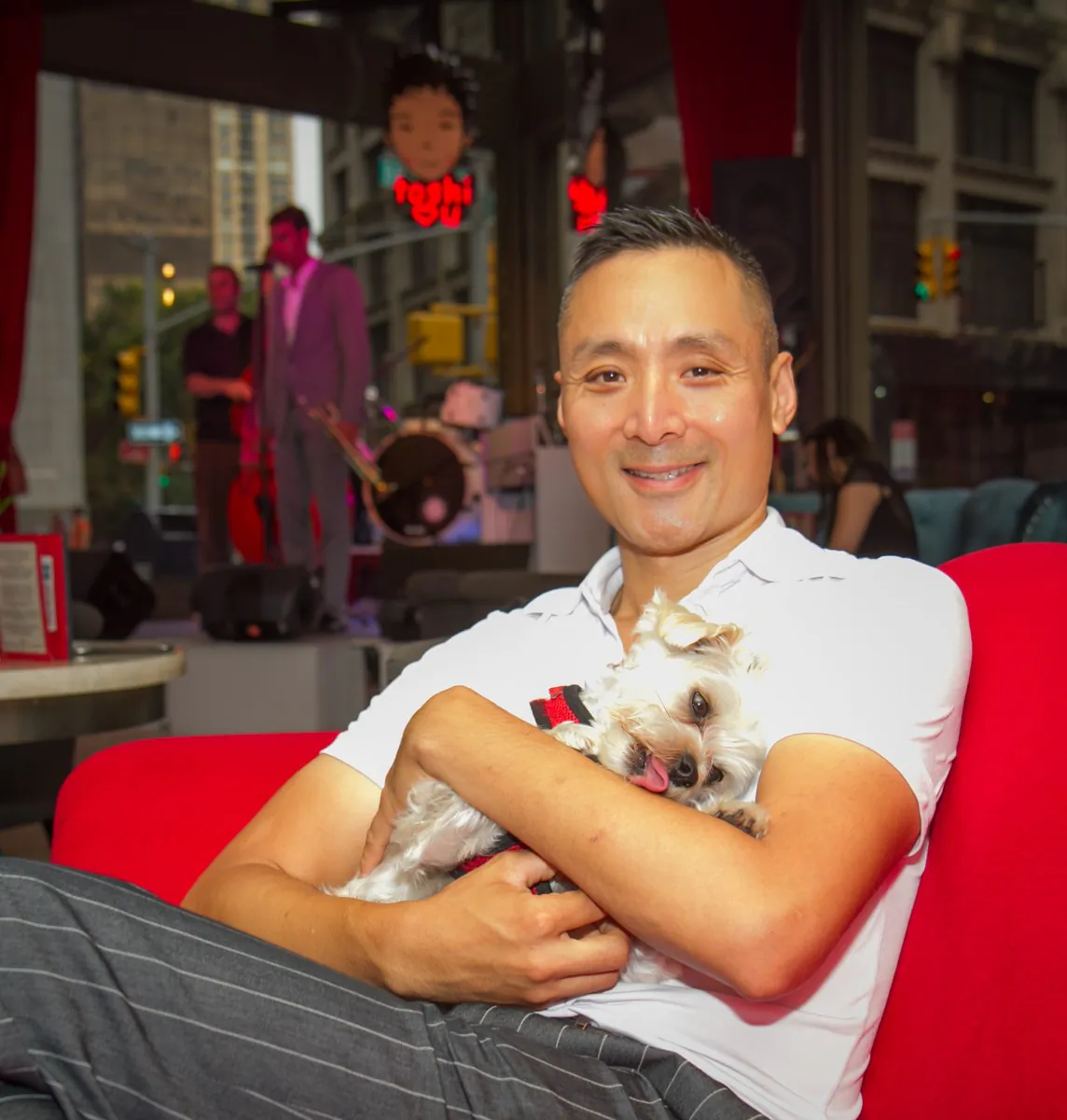 Robert 'Toshi' Chan with his dog Ponzu, on the Penthouse Suite's balcony of his Flatiron Hotel in Manhattan, Aug. 21. (Benjamin Chasteen/The Epoch Times)