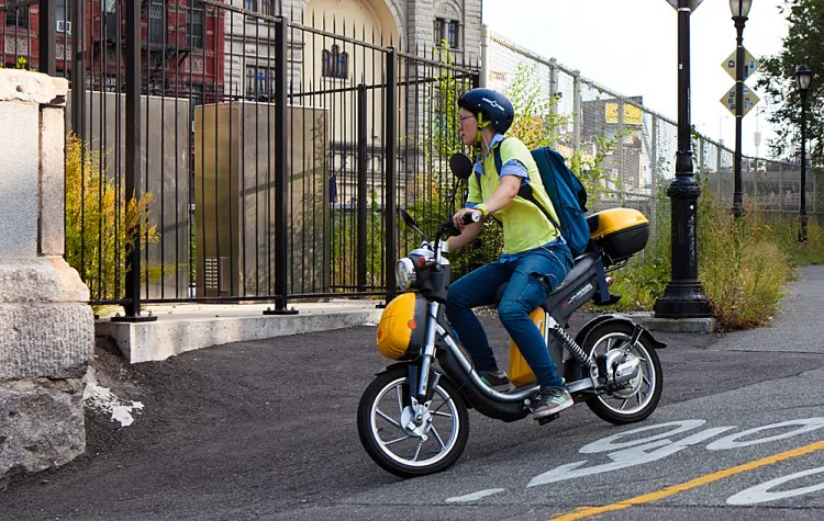 A man on his electric bike on Sixth Ave. (Amal Chen/The Epoch Times)