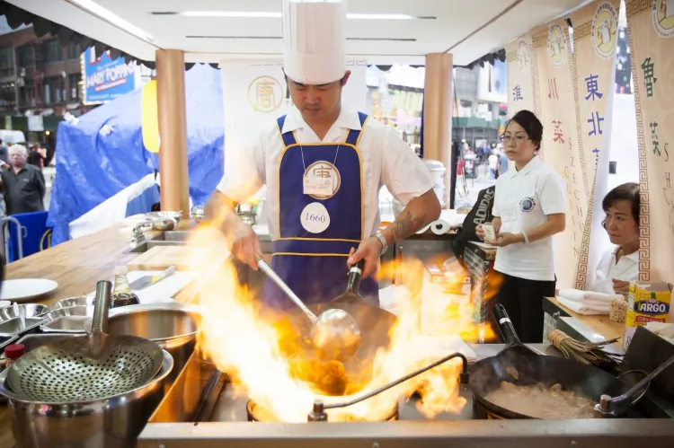 A row of judges assess the quality of Chinese cuisine preparations at the New Tang Dynasty Television’s Fifth Annual International Chinese Culinary Competition in Times Square Sept. 27. (Dai Bing/The Epoch Times)