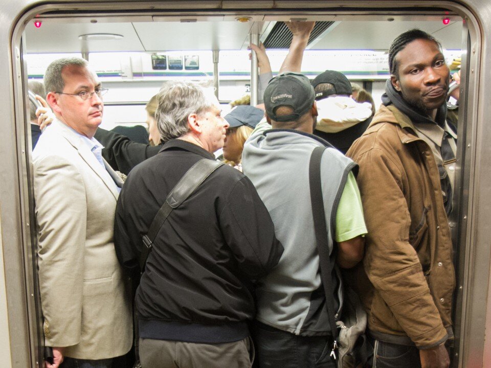Commuters board a crowded No. 6 train heading to Grand Central Terminal during rush hour on Oct. 8 in New York. (Benjamin Chasteen/The Epoch Times)