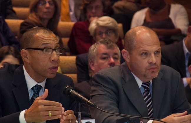 Dennis Walcott (L), chancellor of the city's Department of Education, and Michael Mulgrew, president of the United Federation of Teachers, at a teacher evaluations hearing in New York City on Oct. 16. (Benjamin Chasteen/The Epoch Times)