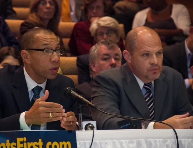 Dennis Walcott (L), chancellor of the city's Department of Education, and Michael Mulgrew, president of the United Federation of Teachers, at a teacher evaluations hearing in New York City on Oct. 16. (Benjamin Chasteen/The Epoch Times)