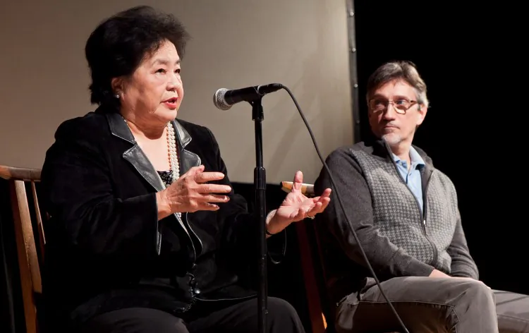 Yasuaki Yamashita, who survived the 1945 atomic bombing in Nagasaki, Japan, shares his personal story with high school students at the Japan Society in New York, as President Harry S. Truman's grandson, Clifton Truman Daniel, listens Oct. 17 in New York. (Amal Chen/The Epoch Times)