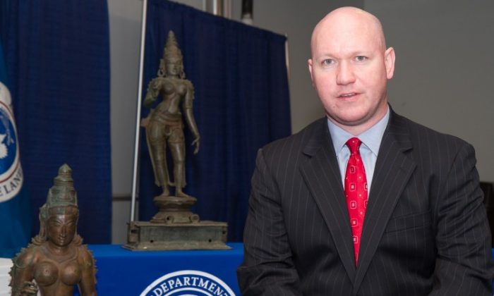 James T. Hayes Jr., special agent of Homeland Security Investigations, sits in front of looted Indian sculptures worth at least $5 million in New York City, Dec. 5, 2012. The sculptures were seized at Port Newark, N.J. (Benjamin Chasteen/The Epoch Times)