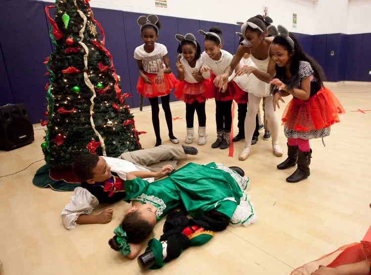Professional ballet dancer Andrei Kisselev jumps in front of children at the Haven Academy Charter School during an event led by Kisselev and another dancer. The students learn the ballet in the morning and perform it with the professional dancers in the afternoon in front of siblings and parents. (Samira Bouaou/The Epoch Times)