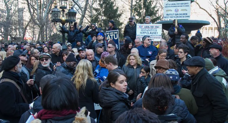School bus drivers, parents, and teachers gather at City Hall Park on Jan. 6 for a rally, trying to pressure city officials into meeting with union officials. (Benjamin Chasteen/The Epoch Times)