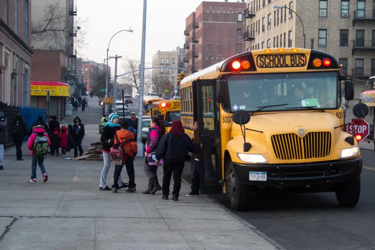 Students exit a school bus in front of their school in the Bronx on Jan. 9, 2013. (Benjamin Chasteen/The Epoch Times)
