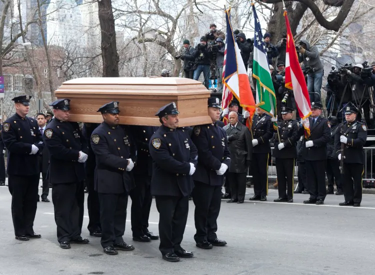 NYPD officers carry the coffin of former New York City Mayor Ed Koch on Fifth Avenue in New York City following his funeral at the Emanu-El temple on Feb. 4. (Samira Bouaou/The Epoch Times)