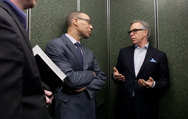 New York City School Chancellor Dennis M. Walcott (L) and Tommy Hilfiger (R) chat on their way up to a classroom in High School of Fashion Industries on the first day of New York City Fashion Week, Feb. 7. (Samira Bouaou/Epoch Times)