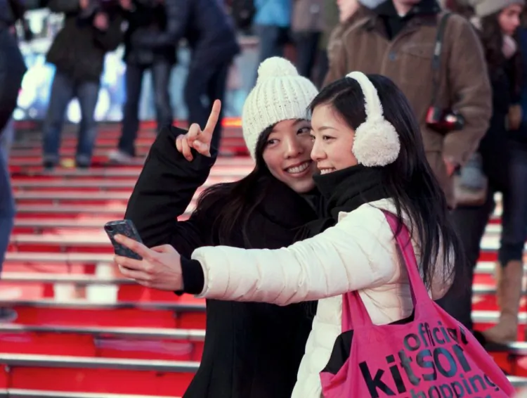 Tourists capture their visit to Times Square, Feb. 20, 2013. (Samira Bouaou/The Epoch Times)
