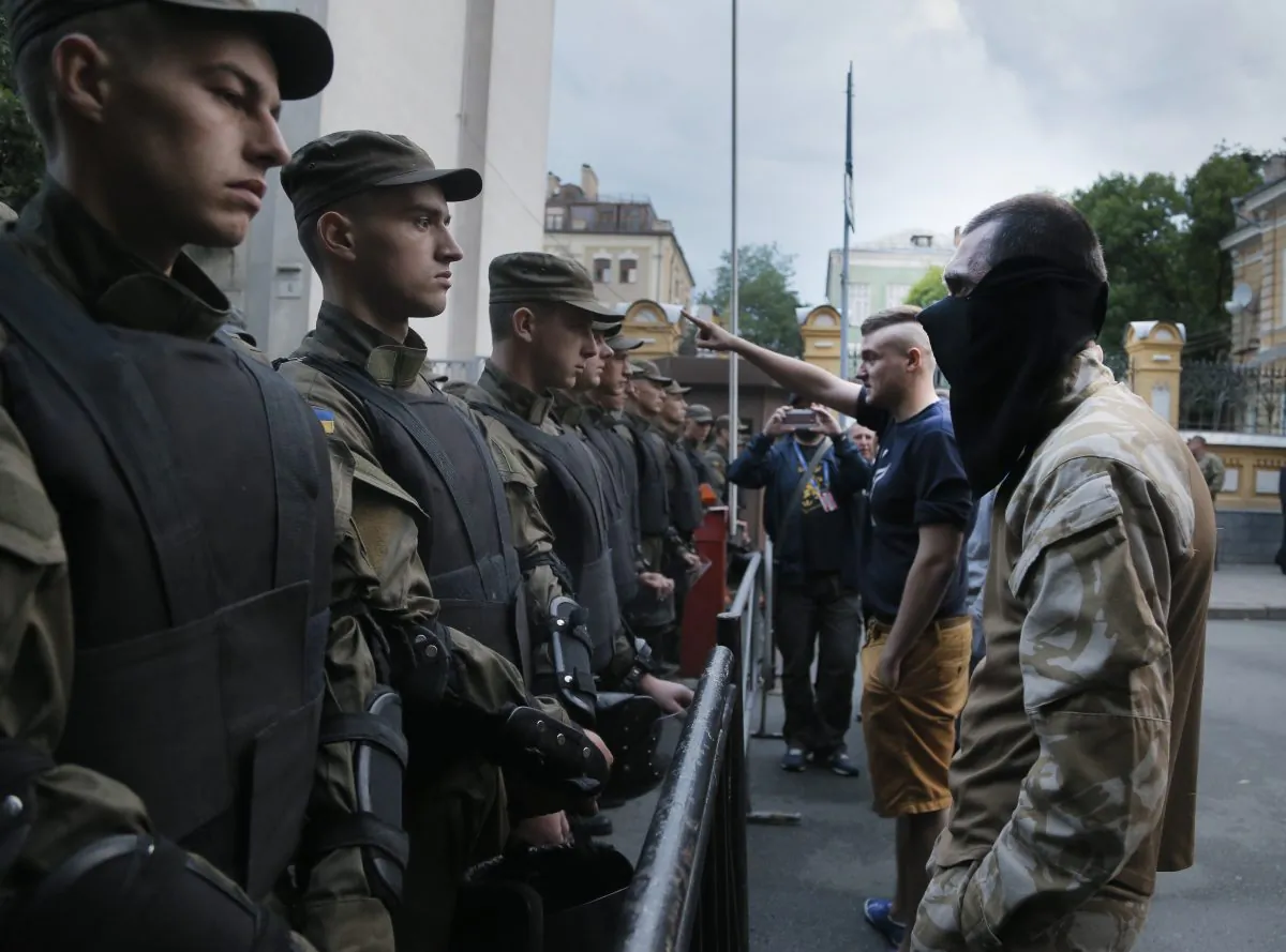 Activists from the Right Sector party confront  police who are blocking a street leading to the Ukrainian Presidential administration building in Kiev, Ukraine, on Saturday, July 11, 2015. (AP Photo/Efrem Lukatsky)