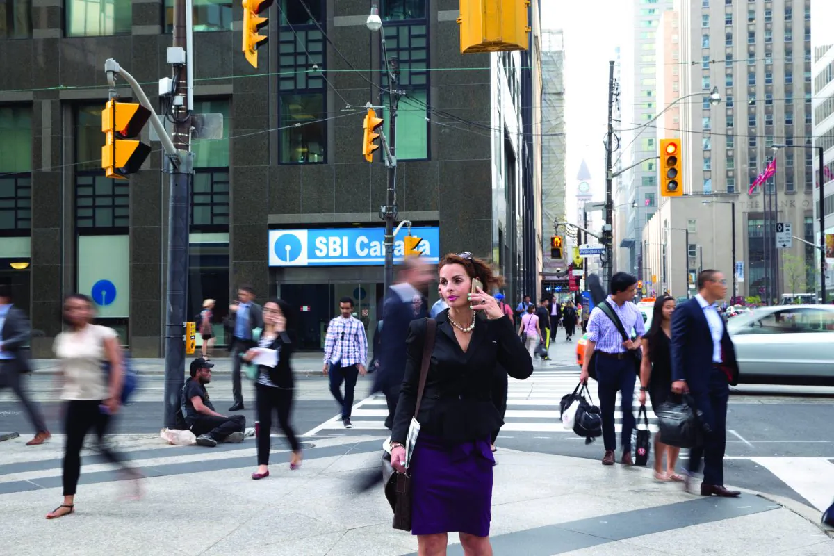 A woman talks on a cellphone in downtown Toronto. The constant busyness inherent in today's work culture is taking an unhealthy toll, leading to a slowly growing "anti-busy" revolution. (Don Quincy/DQC Photo)