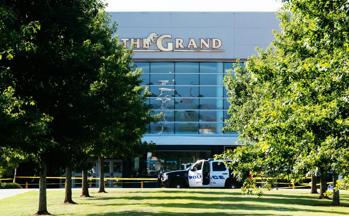 Authorities park at the scene of a Thursday night shooting at The Grand Theatre, in Lafayette, La. on Friday, July 24, 2015. (AP Photo/Denny Culbert)