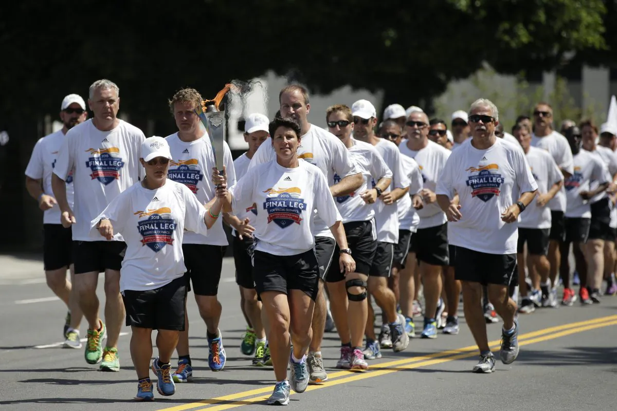 Torchbearers carrying the Flame of Hope arrive at Los Angeles City Hall, Friday, July 24, 2015, in Los Angeles. (AP Photo/Jae C. Hong)