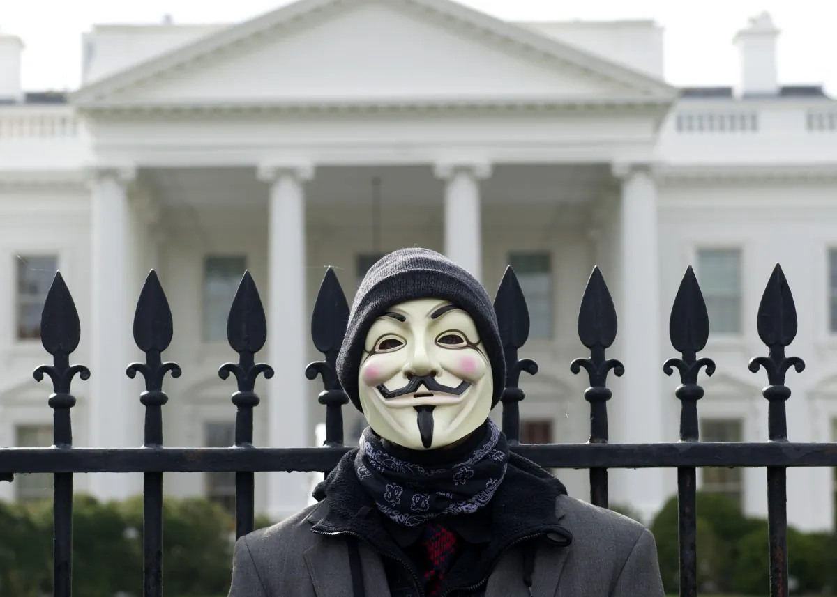 A demonstrator, including supporters of the group Anonymous, poses during a march in protest against corrupt governments and corporations in front of the White House in Washington, DC, November 5, 2013 (SAUL LOEB/AFP/Getty Images)