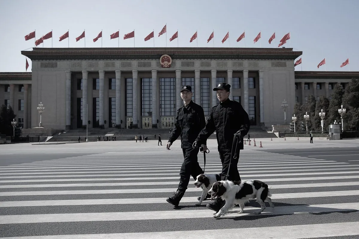 Two policeman leads police dogs guarding in front of the Great Hall of the People before the closing ceremony of the Chinese People's Political Consultative Conference on Mar. 13, 2015 in Beijing, China. (Lintao Zhang/Getty Images)