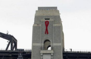 A ribbon to mark the anniversary of World Aids Day hangs from the northern pylon of the Sydney Harbour Bridge. (David Hancock/AFP/Getty Images)