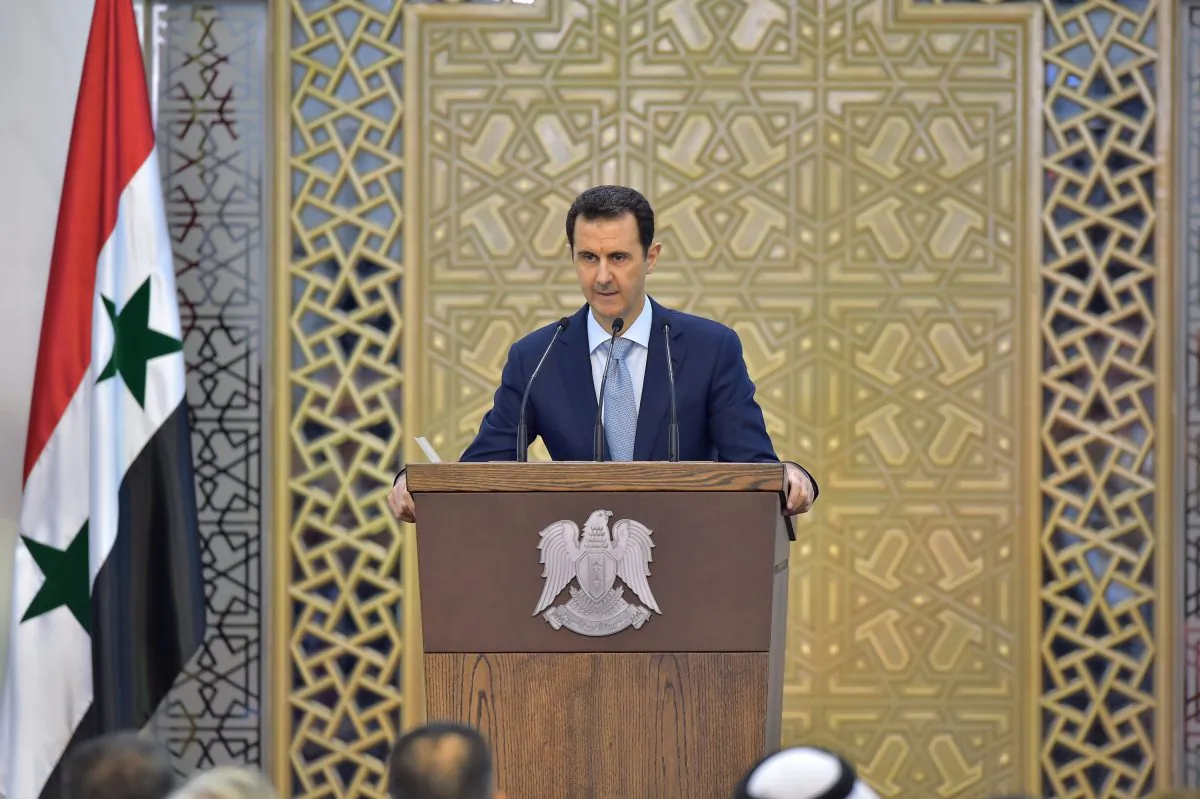 Syrian President Bashar al-Assad delivers a speech in Damascus, Syria, on July 26, 2015. (SANA via AP)