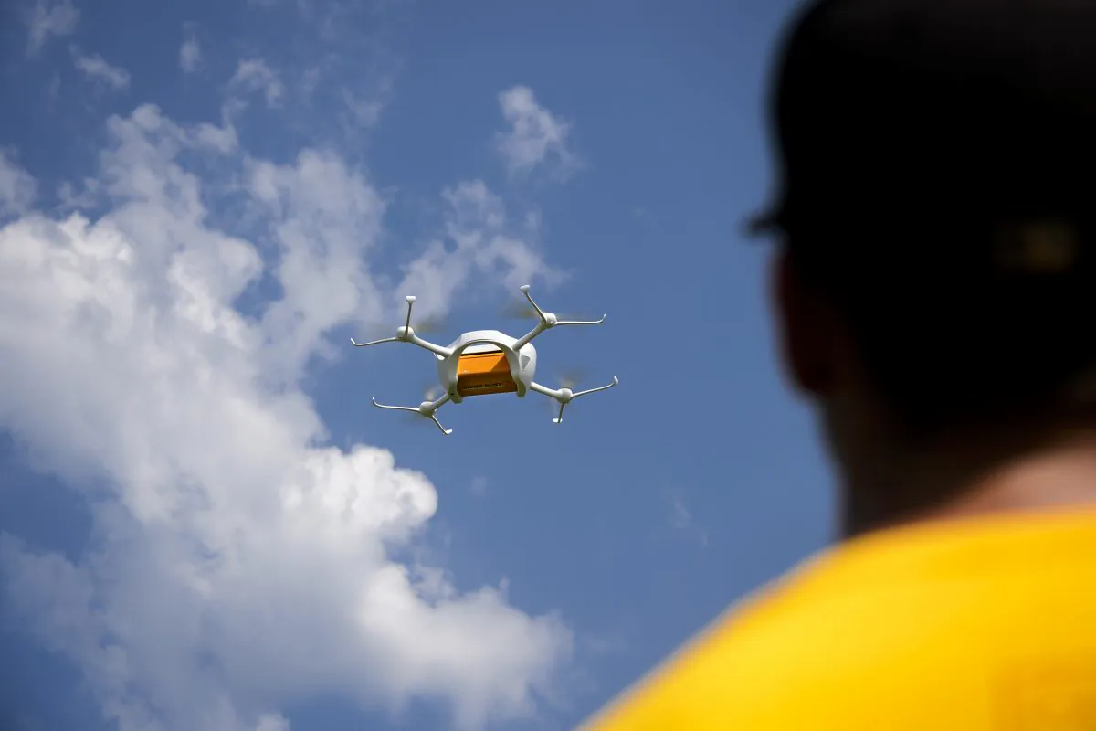 An employee of the US drone compagny Matternet shows a drone carrying a mail box of Swiss Post on July 7, 2015 at the airport of Bellechasse, western Switzerland during a press conference. (Fabrice  Coffrini/AFP/Getty Images)