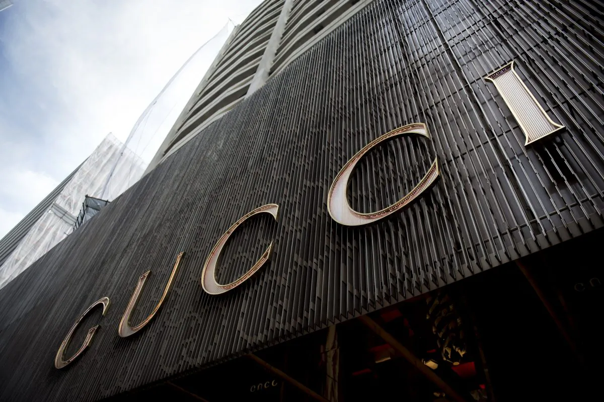 This picture taken on April 23, 2013 shows Chinese mainland tourists sitting outside a Gucci store in Hong Kong. The dazzling display of wealth highlights the booming high-end goods sector driven by cashed-up Chinese who turned swathes of Hong Kong into their luxury shopping playgrounds, as they shop in Hong Kong to avoid China's high taxes. AFP PHOTO / ANTHONY WALLACE (ANTHONY WALLACE/AFP/Getty Images)