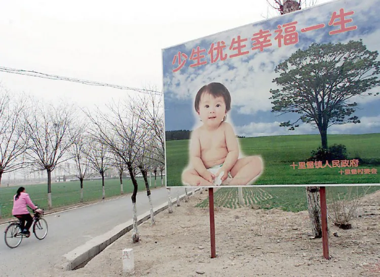 A roadside billboard put up by China's Family Planning Office reads: "Fewer, healthier births will bring a lifetime of happiness." (AFP/Getty Images)
