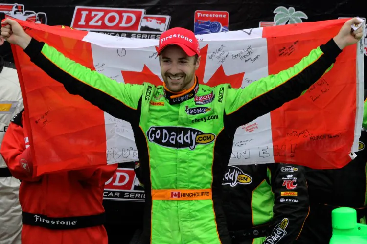 Andretti Autosports driver James Hinchcliffe displays Canada’s flag as he celebrates his first win as an IndyCar driver at the Honda Grand Prix of St. Petersburg in St. Petersburg, Fla. on March 24, 2013. (James Fish/The Epoch Times)