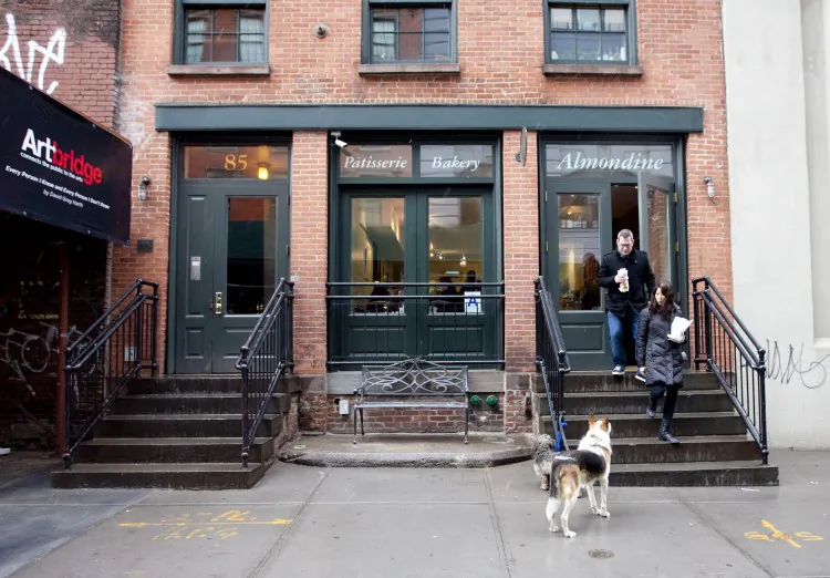 Sinthia Habib serves regular Almondine customers Scott Moe and Rebecca Hume. (Samira Bouaou/The Epoch Times)
