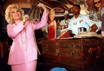 A photo from Apr. 11, 1999 that shows actress Zsa Zsa Gabor (L) holding a beaded purse once owned by actress Marilyn Monroe. (Kim Kulish/AFP/Getty Images)