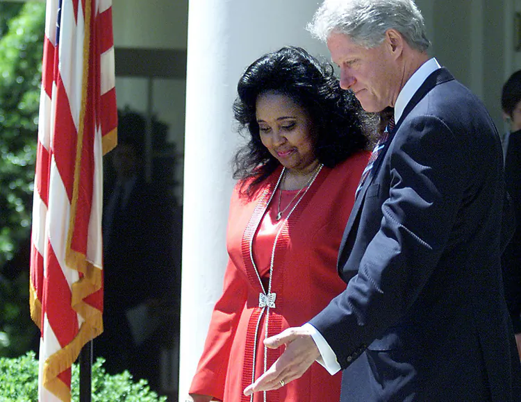 In this May 2000 photo, President Bill Clinton leads Karen Bethea into the White House rose garden to announce several measures seeking to narrow the wage gap for women. Up to today, numerous studies are being published worldwide every year that continue to find women are being paid less than men. (Tim Sloan/AFP/Getty Images)