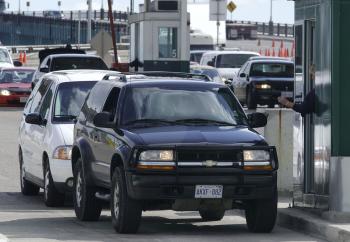 Vehicles stop at a border checkpoint in Detroit after crossing Ambassador Bridge which connects Detroit, Mich. and Windsor, Ont. With layers of new regulations and inspections often leading to long wait times, the Canadian Chamber of Commerce is calling f (Jeff Kowalsky/AFP/Getty Images)