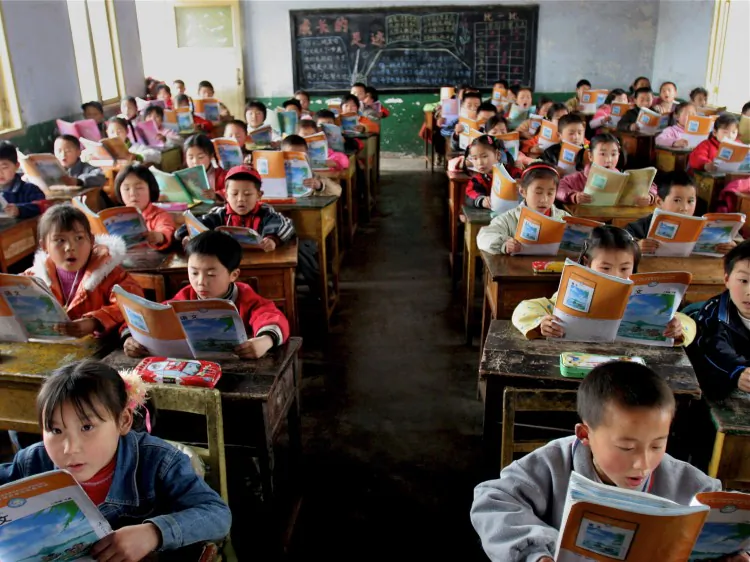 In Sichuan Province, an elementary school class reads the standardized textbooks for learning Chinese. (China Photos/Getty Images)