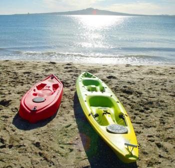 Kayaks resting on a New Zealand beach. (Getty Images)