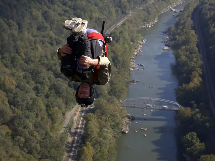 On October 15, 2012, a BASE jumper soars over the New River Gorge after jumping from the New River Bridge in West Virginia, where 831 jumpers jumped from the 876ft span into the river valley below. (Jeff Swensen/Getty Images)